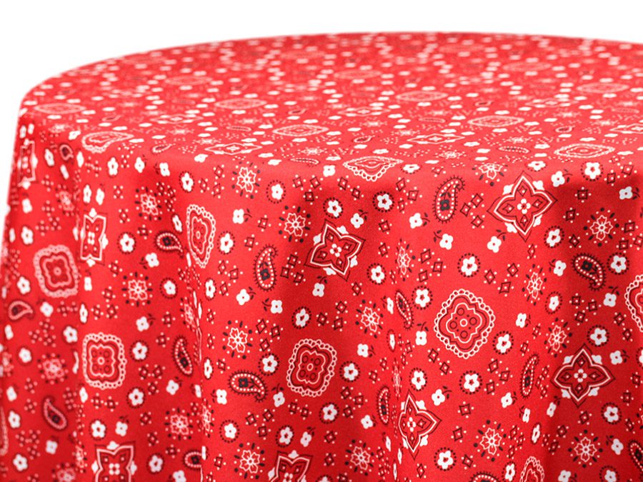 Red tablecloth with white floral and geometric patterns.