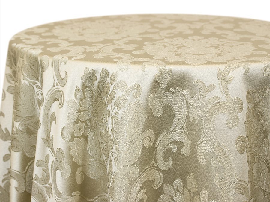Elegant cream-colored damask tablecloth with floral patterns on a round table.