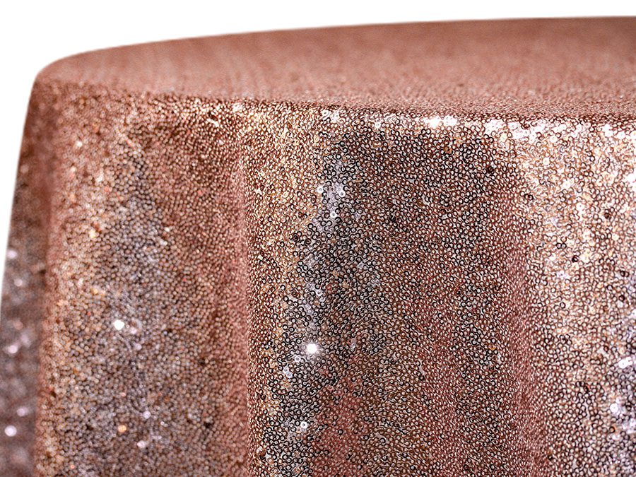 Close-up of a sparkling rose gold sequin fabric.