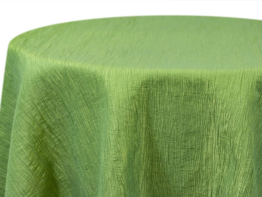 Green textured tablecloth draped over a round table.
