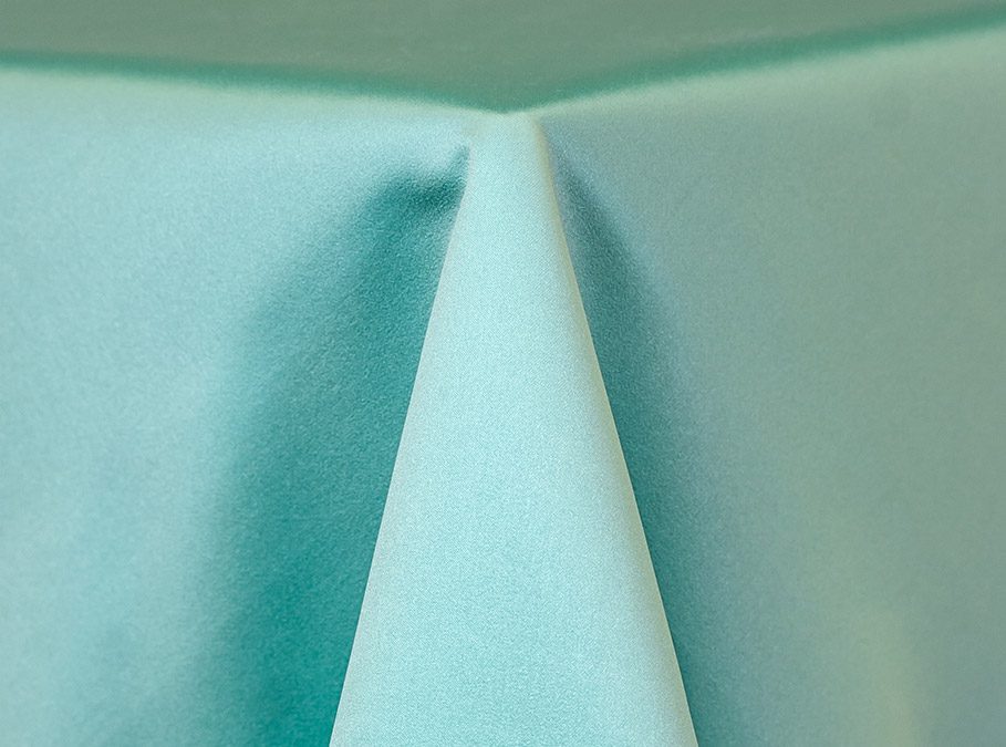 Close-up of a light blue fabric with a prominent fold.