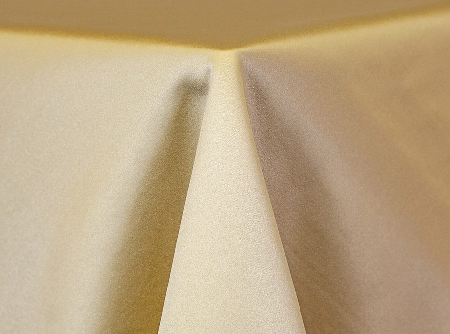 Close-up of beige fabric folds with soft texture.