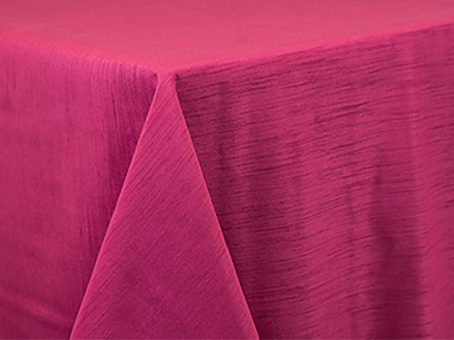 Close-up of vibrant pink fabric with visible texture and folds.
