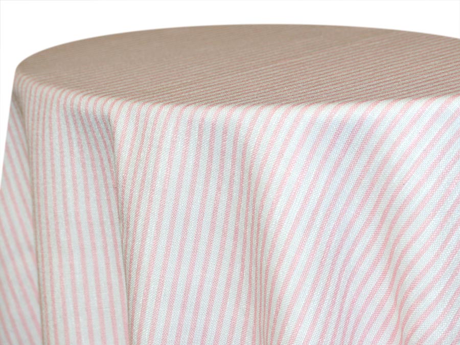 Round table covered with white cloth with pink stripes.