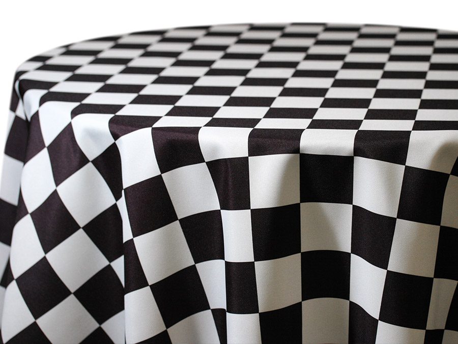 Black and white checkered tablecloth draped over a round table.