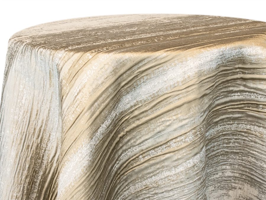 Close-up of a textured, beige fabric draped over a surface.