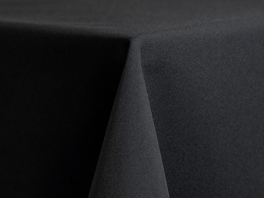 Close-up of a black textured fabric folded at a corner.