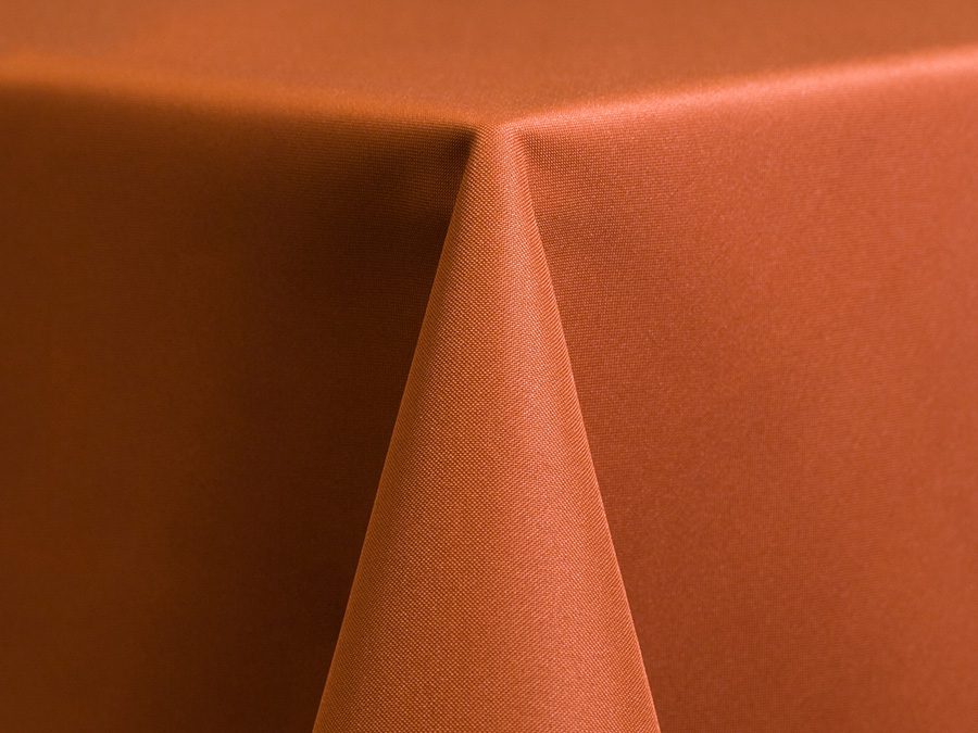 Close-up of a rust-colored fabric with a sharp fold.