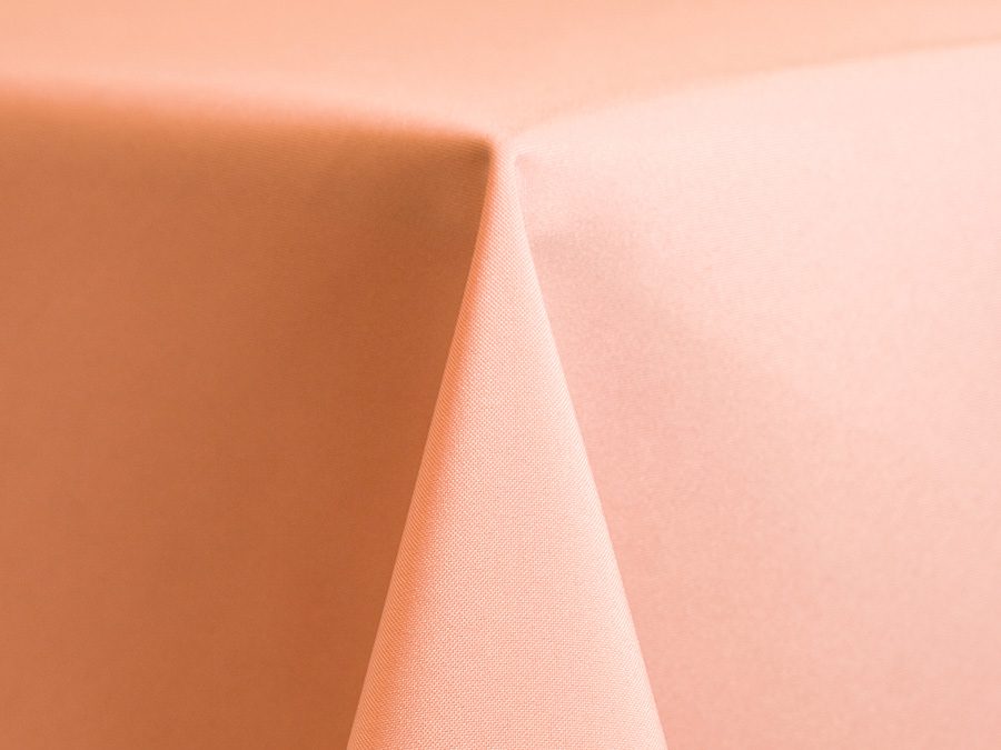 Close-up of a peach-colored fabric corner with soft folds.