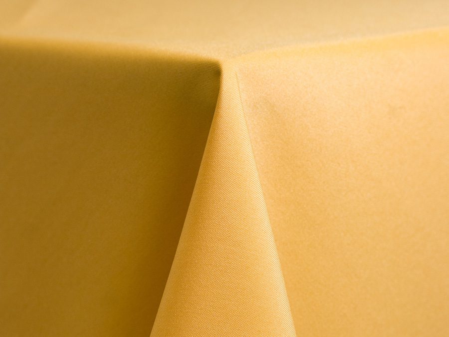 Close-up of smooth, mustard-yellow fabric folds.