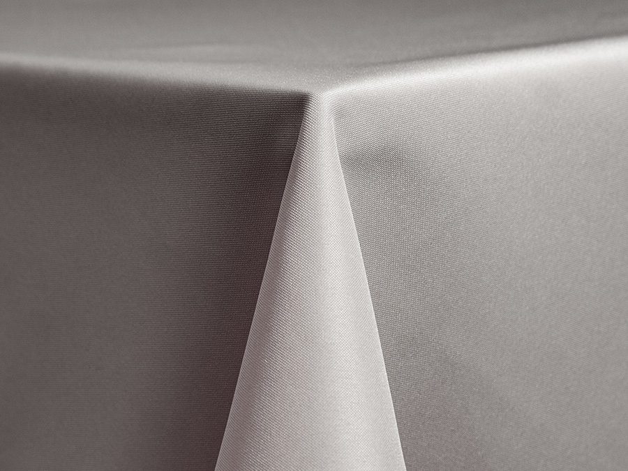 Close-up of a neatly draped, smooth gray tablecloth corner.