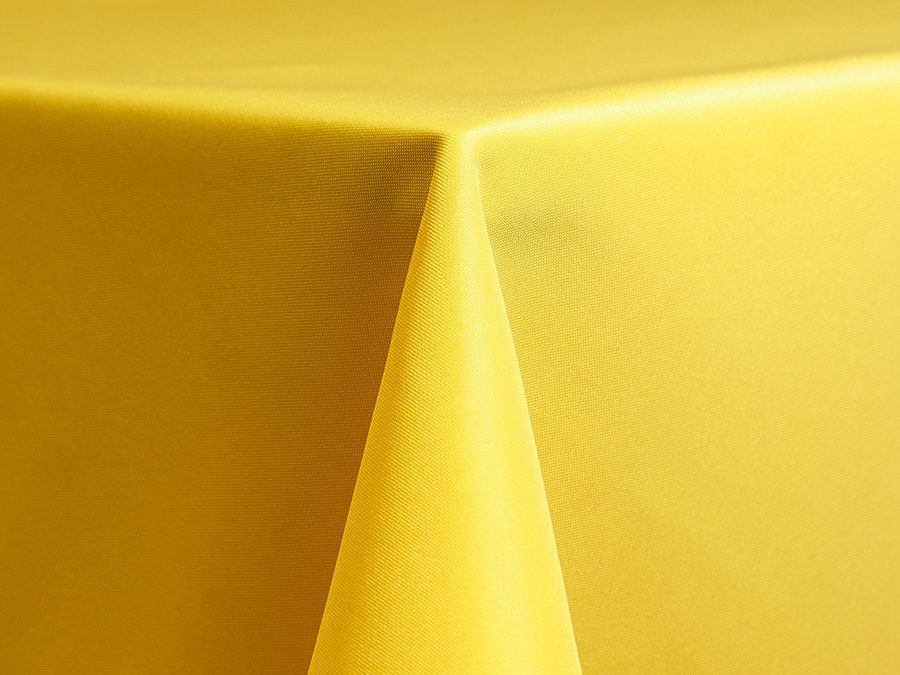 Close-up of a yellow tablecloth corner on a table.