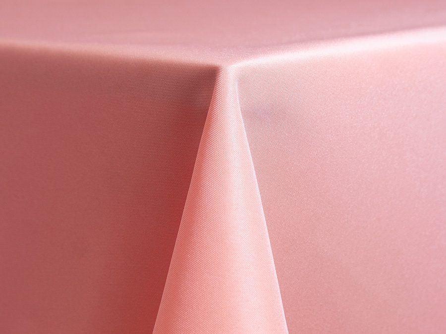 A pink tablecloth draped neatly over a table corner.