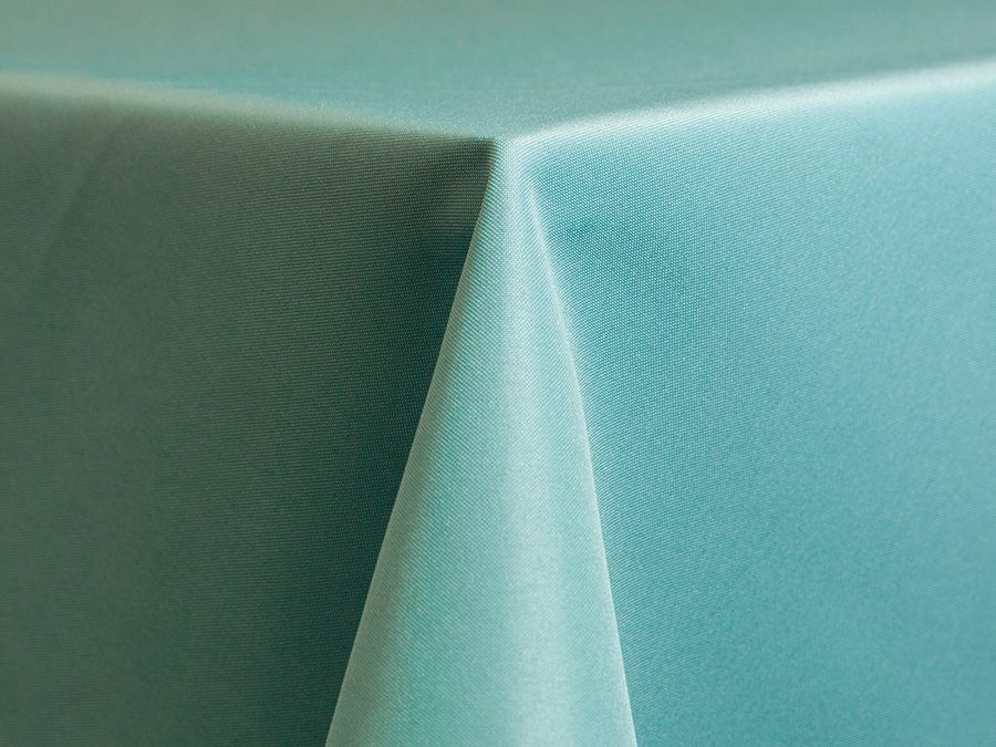 Close-up of two pastel-colored tablecloths meeting at a corner.