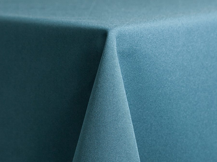 Close-up of a teal fabric draped over a corner.