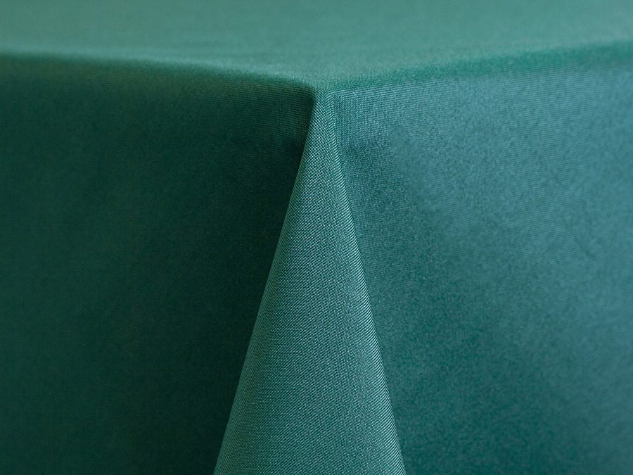 Close-up of a teal fabric tablecloth corner.